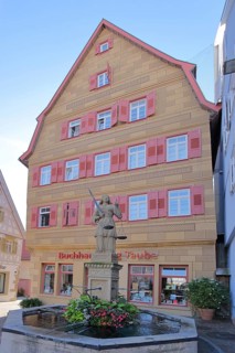 Market fountain with figure of Justitia and historic half-timbered house