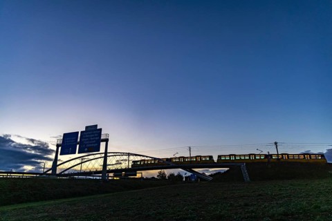 Network arch bridge over the A8 motorway. Light rail bridge of the SSB for the U6 airport line. The span of the arches is 80 metres. Tension elements made of carbon. The U6 line light rail bridge rece...