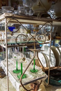 Old wine and liquor glasses for sale inside second hand goods and chattels store