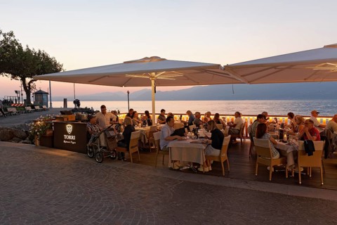 Restaurant terrace with guests on the lake shore