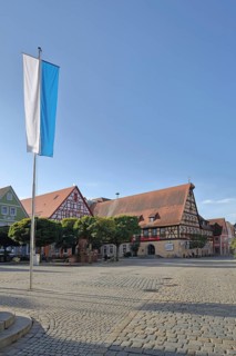 Market place with Bavarian flag and half-timbered house