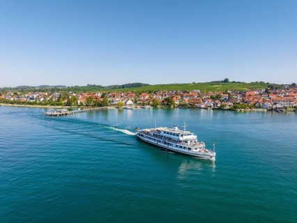 Aerial view of the Lake Constance municipality of Hagnau with the landing stage and the departing scheduled ship MS Swabia of the Lake Constance-Schiffsbetriebe