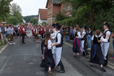 Dance of the Kirchweih couples with brass band on the street on the day of the traditional Tanzlindenfest