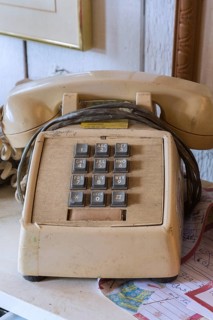 Vintage touch tone analog telephone for sale inside second hand goods and chattels store