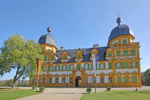 Baroque Seehof Castle with German national flag and Bavarian state flag