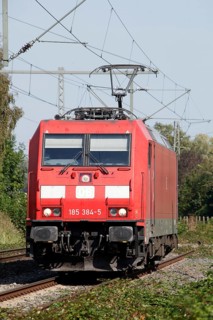 Red locomotive class 185 on a railway track