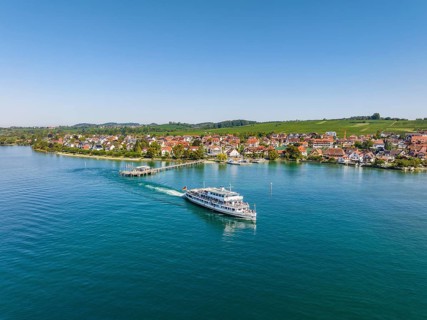 Aerial view of the Lake Constance municipality of Hagnau with the landing stage and the departing scheduled ship MS Swabia of the Lake Constance-Schiffsbetriebe