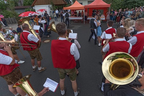 Dance of the Kirchweih couples with brass band on the street on the day of the traditional Tanzlindenfest