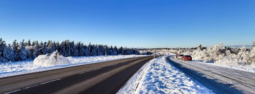 Snow-covered landscape and Black Forest High Road in winter near Baiersbronn