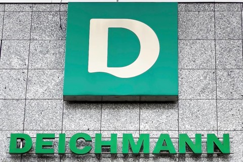 Logo of family business shoe manufacturer retail for shoes Deichmann below lettering on building with headquarters in Essen