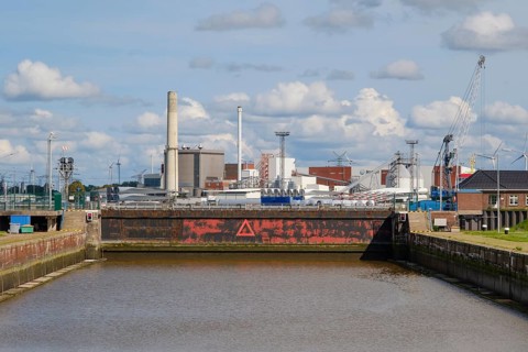 Sea lock in front of industrial harbour