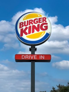 Logo and advertisement for the fast food chain Burger King with the words Drive In below