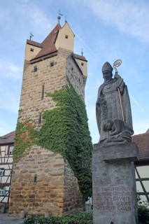 Historic Fehnturm built 13th century and sculpture Saint at the well with bible quotation from John 4-14