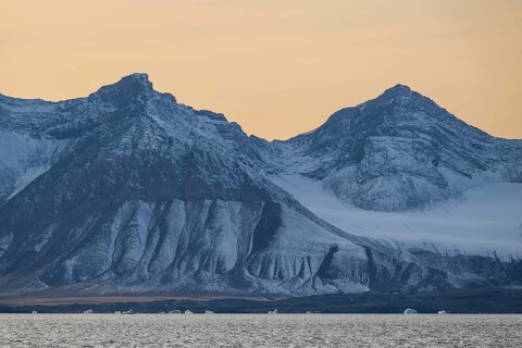 Icebergs in front of mountain range