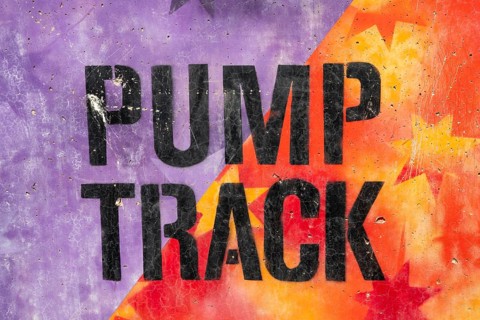 Black Pumptrack lettering against a colourful background