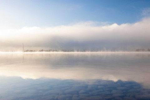 Fog over Lake Constance on an autumn morning with boats