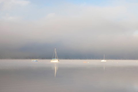 Fog over Lake Constance on an autumn morning with boats