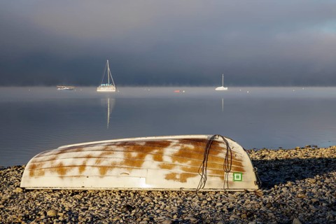 Fog over Lake Constance on an autumn morning with boats