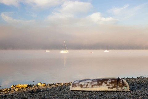 Fog over Lake Constance on an autumn morning with boats