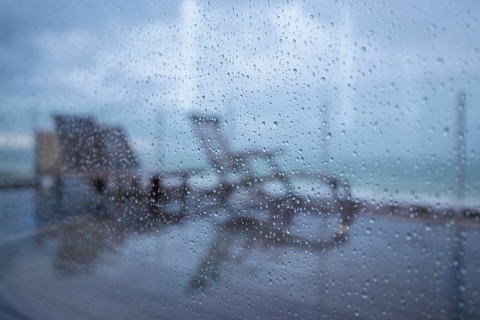 Raindrops on a window pane looking out onto the terrace