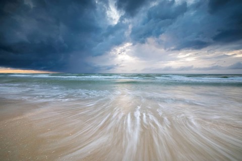 Evening mood with cloudy sky and rain on the beach and in the dunes of De Panne