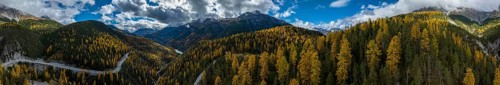 Colourful autumn landscape with a view of the Swiss National Park and the Lai dad Ova Spin reservoir