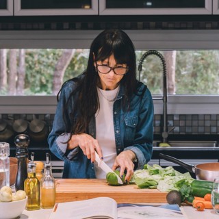Woman reading recipe while preparing food