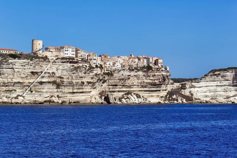 Upper town with the staircase of the King of Aragon on white chalk cliffs