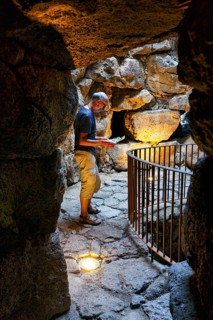 Tourist exploring Nuraghe Santu Antine