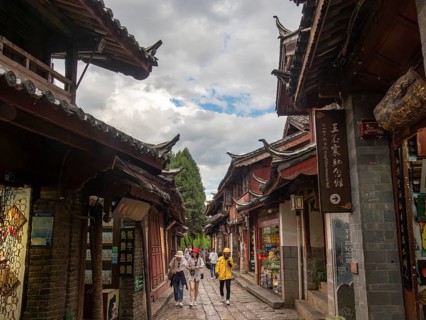 Alleys with old Chinese wooden houses and strolling passers-by