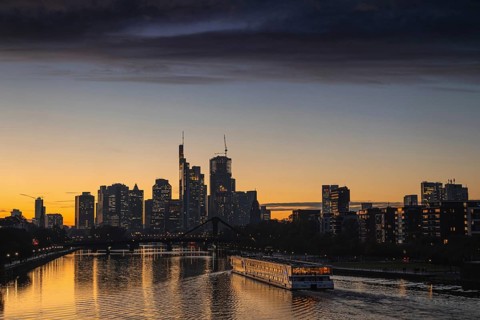 A dense band of clouds passes over Frankfurt's banking skyline in the evening shortly after sunset