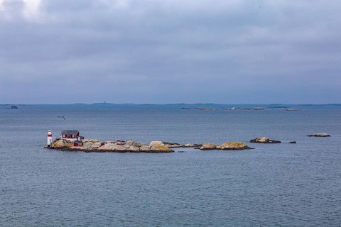 Typical tiny archipelago island with lighthouse and lighthouse keeper's house