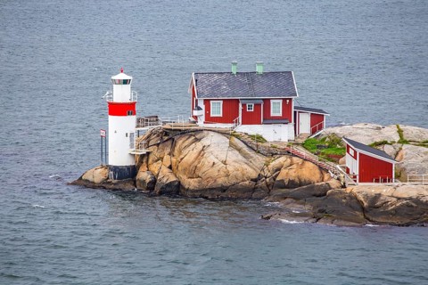 Typical tiny archipelago island with lighthouse and lighthouse keeper's house