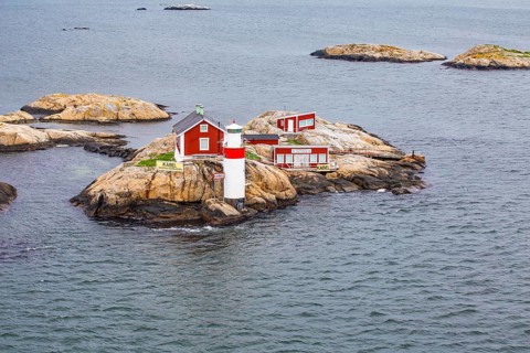 Typical tiny archipelago island with lighthouse and lighthouse keeper's house