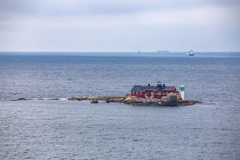 Typical tiny archipelago island with lighthouse and lighthouse keeper's house