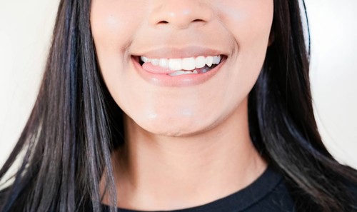 Close up of sexy girl biting tongue. Girl mouth biting her tongue isolated