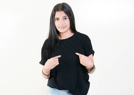 Embarrassed young woman pointing at herself isolated. Confused girl pointing at herself isolated