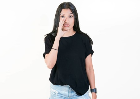 Girl whispering to the camera