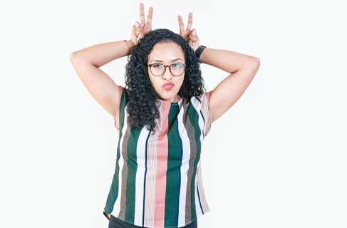 Afro girl making horns gesture with their fingers