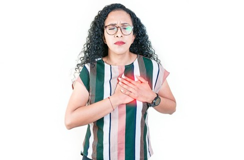 Afro woman with heart pain touching chest isolated. Afro girl with tachycardia. People with heart problems