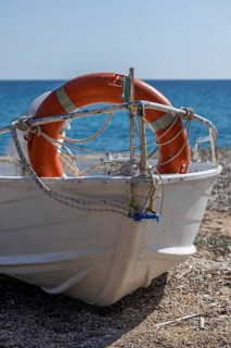 Boat with life belt on the beach