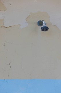 Shower on a weathered wall on the beach