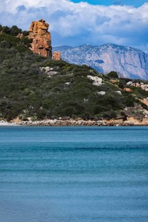 Landscape with red rocks and bright blue sea