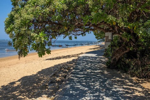 Sunrise on the sandy beach. Landscape shot with a view of the sea and the beach. Waves of light and a morning atmosphere that only exists in Sanur