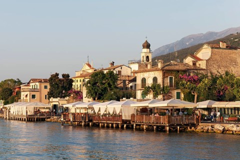Lake shore with restaurant terraces and historic old town