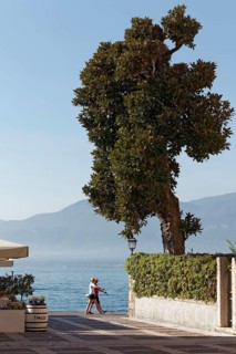 Couple walking in step on the lakeside promenade