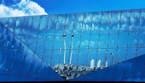 Reflection of the TV tower in the glass façade of the Cube at the main station