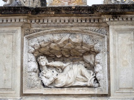 Reclining figure of a saint