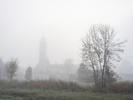 Church tower in the morning mist