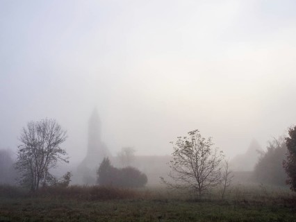 Church tower in the morning mist